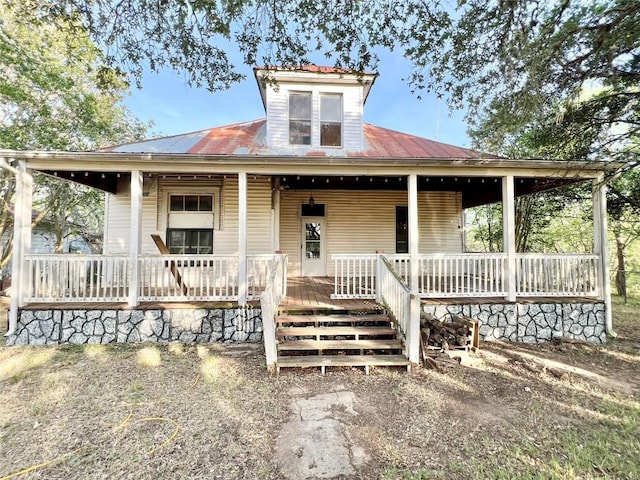view of front of home featuring a porch and metal roof