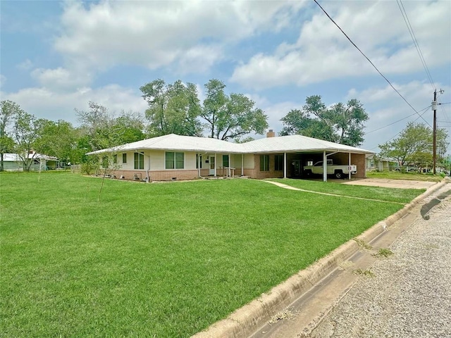 419 N Knox Ave, Giddings, TX 78942 - view of front of property with a chimney, an attached carport, brick siding, a front lawn, and driveway
