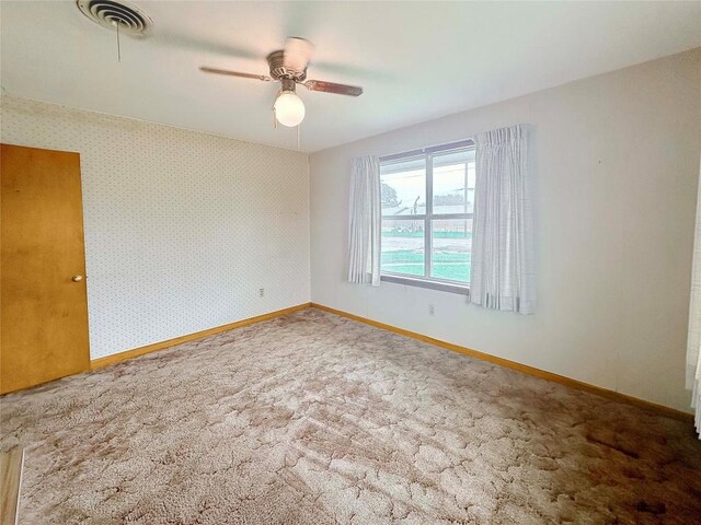 419 N Knox Ave, Giddings, TX 78942 - carpeted spare room with ceiling fan and baseboards