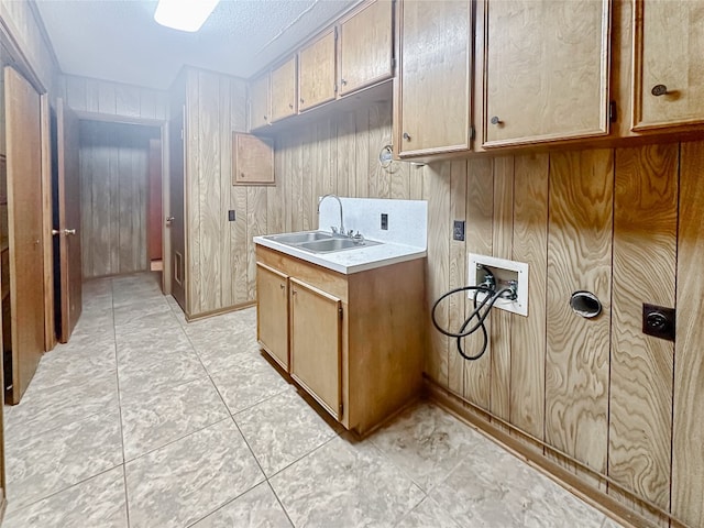 419 N Knox Ave, Giddings, TX 78942 - washroom featuring washer hookup, cabinet space, and wood walls