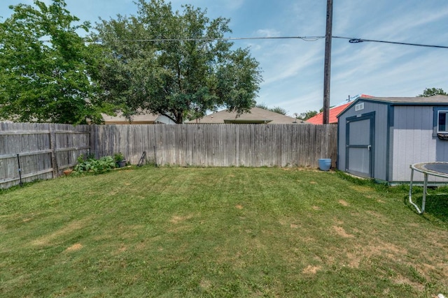 299 Andesite Trl, Buda, TX 78610 - view of yard featuring a storage unit, an outdoor structure, and a trampoline