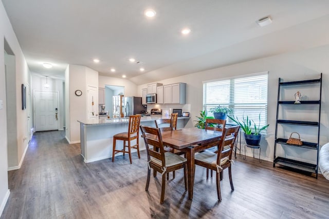 299 Andesite Trl, Buda, TX 78610 - dining room featuring baseboards, dark wood-style floors, recessed lighting, and vaulted ceiling