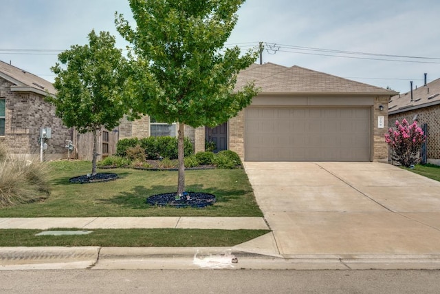 299 Andesite Trl, Buda, TX 78610 - view of front of home featuring a garage, driveway, a front lawn, and brick siding
