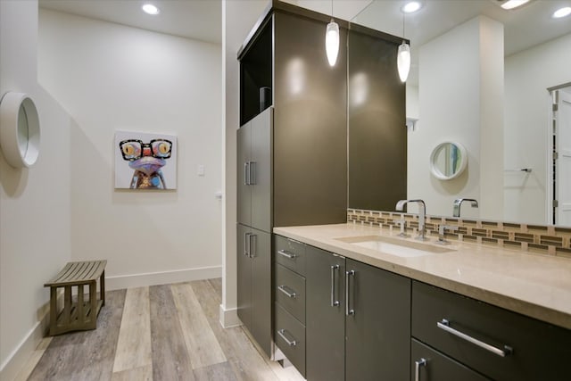 116 Wennmohs Pl, Horseshoe Bay, TX 78657 - bathroom featuring vanity, wood finished floors, backsplash, baseboards, and recessed lighting