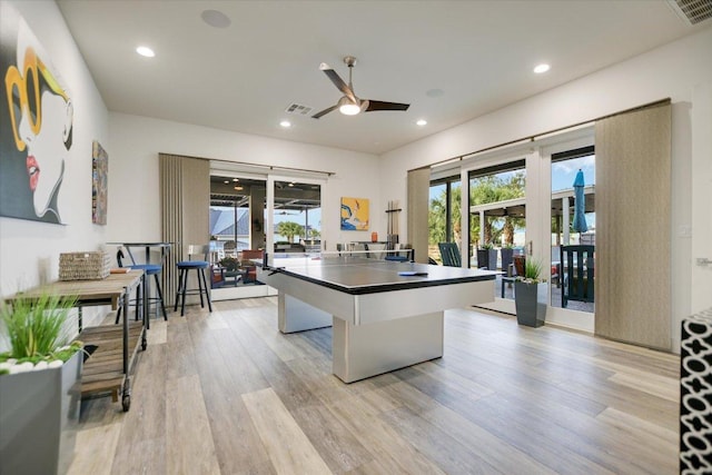 116 Wennmohs Pl, Horseshoe Bay, TX 78657 - kitchen featuring light wood finished floors, a ceiling fan, recessed lighting, dark countertops, and a kitchen island