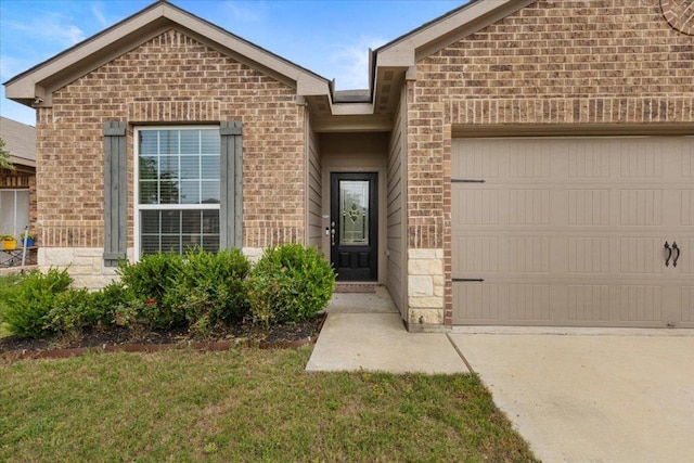 321 Freedom Park Ave, Liberty Hill, TX 78642 - doorway to property with brick siding, a garage, driveway, and a yard