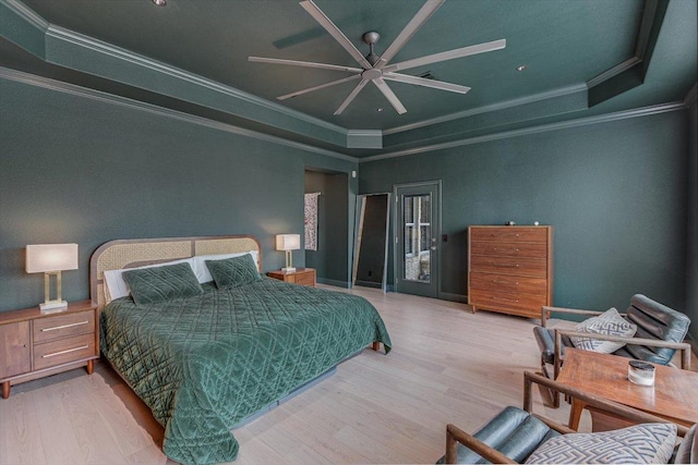 bedroom featuring ornamental molding, wood finished floors, a ceiling fan, access to outside, and a raised ceiling