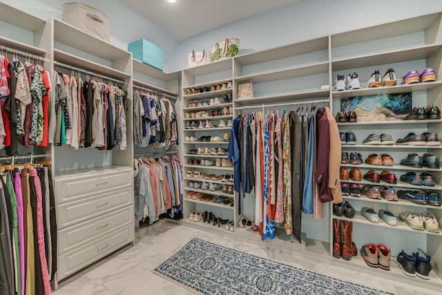 spacious closet featuring light marble finish flooring