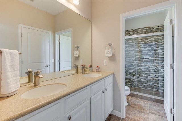 bathroom with toilet, a stall shower, double vanity, and tile patterned floors