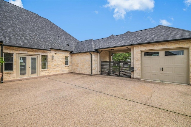 exterior space with french doors and concrete driveway