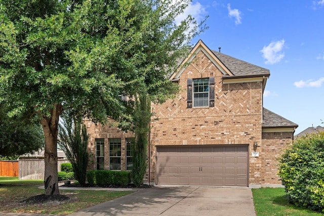 2640 Estefania Ln, Round Rock, TX 78665 - traditional home with concrete driveway, brick siding, an attached garage, and roof with shingles