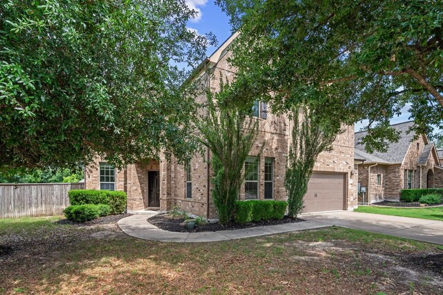 2640 Estefania Ln, Round Rock, TX 78665 - obstructed view of property with brick siding, driveway, and a garage