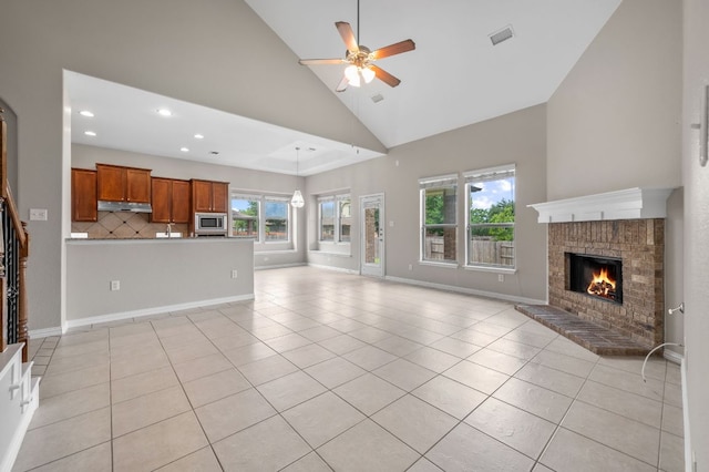 2640 Estefania Ln, Round Rock, TX 78665 - unfurnished living room with high vaulted ceiling, ceiling fan, recessed lighting, a fireplace, and light tile patterned flooring