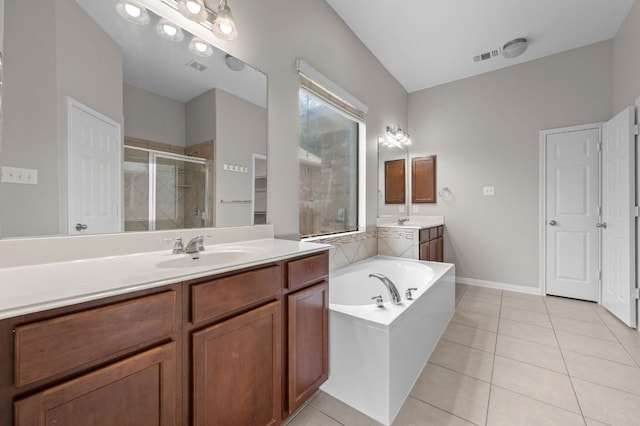 2640 Estefania Ln, Round Rock, TX 78665 - full bath featuring a shower stall, two vanities, a bath, and tile patterned flooring