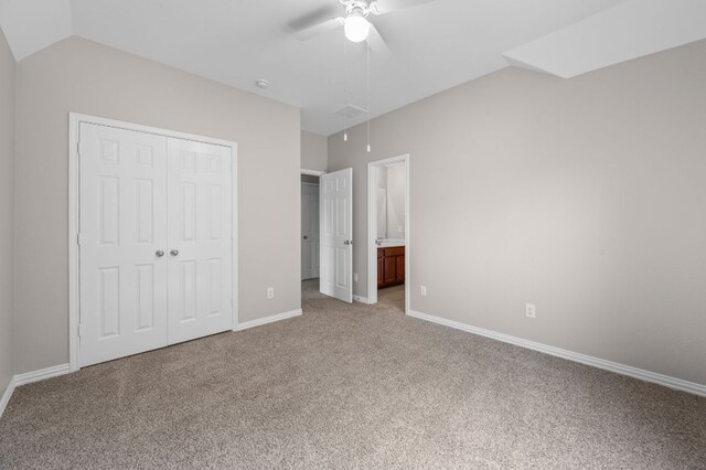 2640 Estefania Ln, Round Rock, TX 78665 - unfurnished bedroom featuring light colored carpet, attic access, vaulted ceiling, a closet, and a ceiling fan