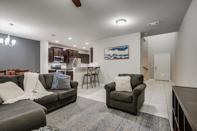 516 E Slaughter Ln Unit 1203, Austin, TX 78744 - living area featuring light tile patterned floors, a chandelier, recessed lighting, baseboards, and ceiling fan