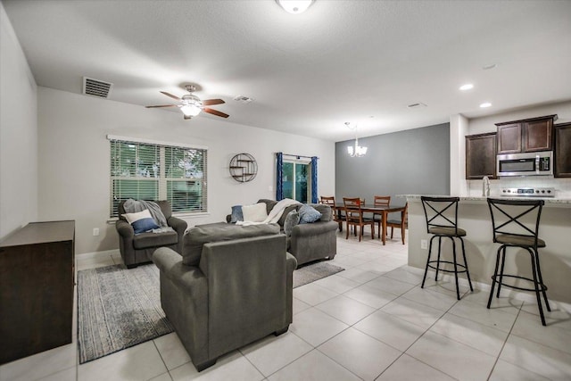 516 E Slaughter Ln Unit 1203, Austin, TX 78744 - living area with a chandelier, ceiling fan, light tile patterned floors, and recessed lighting