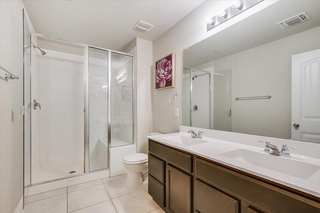 516 E Slaughter Ln Unit 1203, Austin, TX 78744 - full bathroom featuring tile patterned floors, a stall shower, toilet, and double vanity