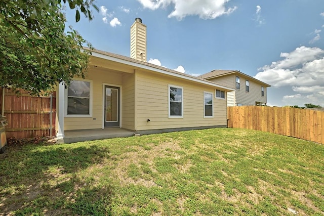 9403 Brandts Wood St, Austin, TX 78744 - rear view of property with a chimney and a patio area