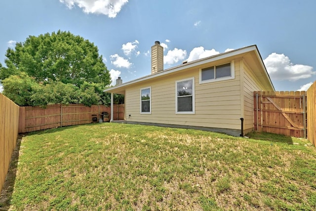 9403 Brandts Wood St, Austin, TX 78744 - rear view of property with a fenced backyard and a chimney