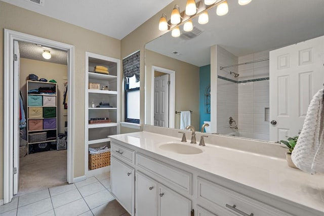 5503 Courtyard Dr, Austin, TX 78731 - full bath with vanity, tile patterned flooring, a spacious closet, and a shower