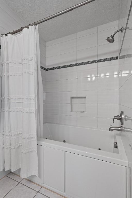5503 Courtyard Dr, Austin, TX 78731 - bathroom with tile patterned flooring, a textured ceiling, and shower / tub combo with curtain