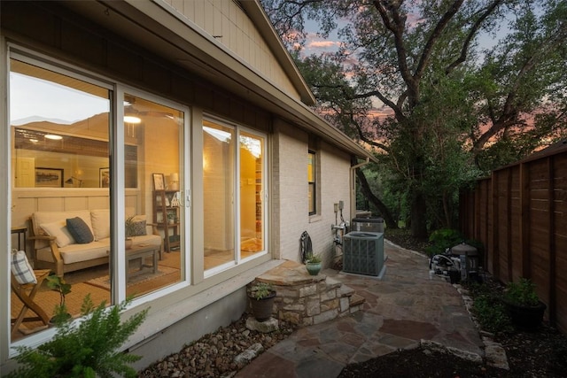 5503 Courtyard Dr, Austin, TX 78731 - patio terrace at dusk featuring fence and central AC unit