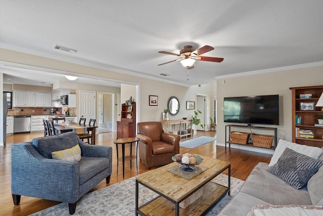 5503 Courtyard Dr, Austin, TX 78731 - living area with light wood-style flooring, a ceiling fan, and ornamental molding