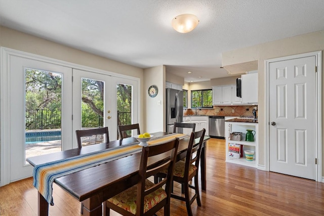 5503 Courtyard Dr, Austin, TX 78731 - dining area featuring light wood-style flooring and french doors