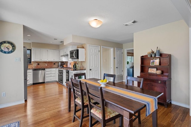 5503 Courtyard Dr, Austin, TX 78731 - dining room with baseboards and light wood-type flooring