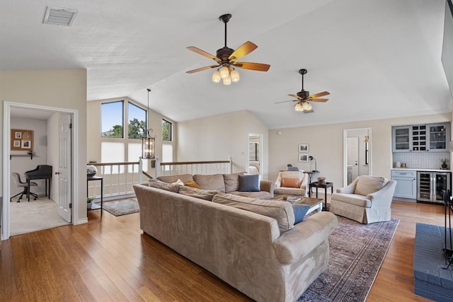 5503 Courtyard Dr, Austin, TX 78731 - living area featuring beverage cooler, lofted ceiling, light wood-type flooring, a ceiling fan, and a dry bar