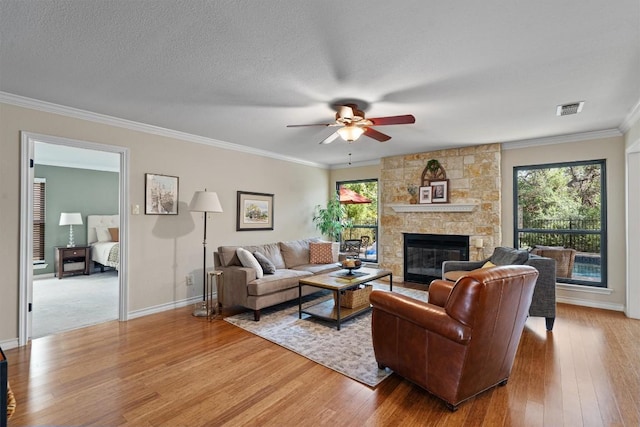 5503 Courtyard Dr, Austin, TX 78731 - living area featuring light wood-type flooring, a ceiling fan, ornamental molding, and a fireplace