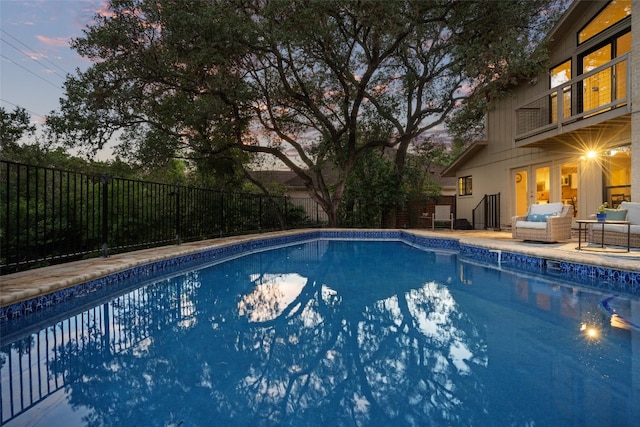 5503 Courtyard Dr, Austin, TX 78731 - pool at dusk with fence and outdoor lounge area