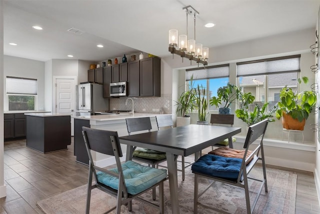 141 Witchhazel Way, San Marcos, TX 78666 - dining space featuring wood finished floors, recessed lighting, and a chandelier