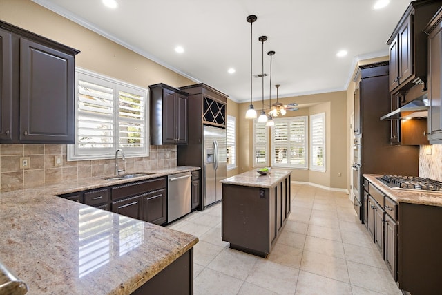 214 Lone Star Dr, Georgetown, TX 78633 - kitchen with stainless steel appliances, tasteful backsplash, crown molding, a center island, and light stone countertops