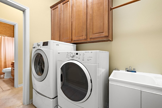 214 Lone Star Dr, Georgetown, TX 78633 - laundry area with washer and clothes dryer, cabinet space, and light tile patterned floors