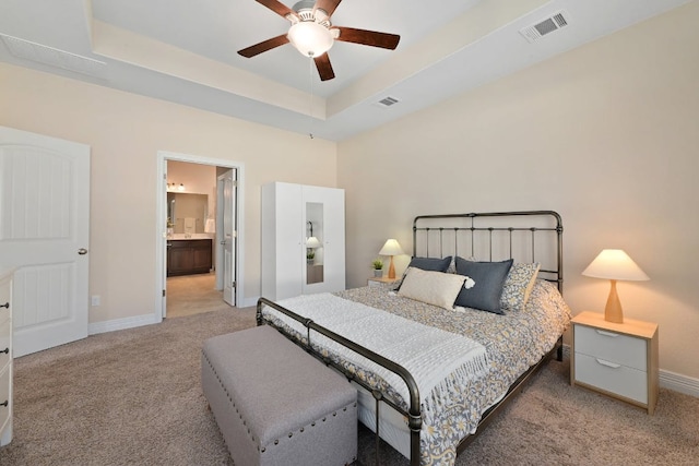 6321 Llano Stage Trl, Austin, TX 78738 - bedroom featuring light carpet, baseboards, ceiling fan, ensuite bath, and a tray ceiling