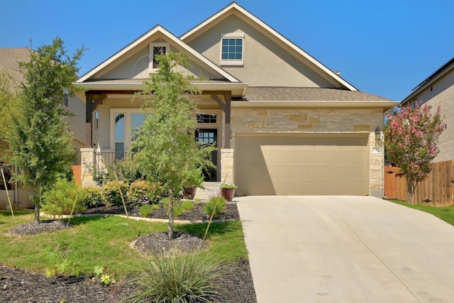 6321 Llano Stage Trl, Austin, TX 78738 - view of front facade featuring stone siding, driveway, an attached garage, and stucco siding