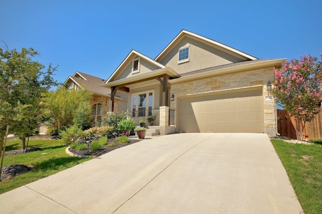 6321 Llano Stage Trl, Austin, TX 78738 - view of front of property with stone siding, concrete driveway, a garage, and stucco siding