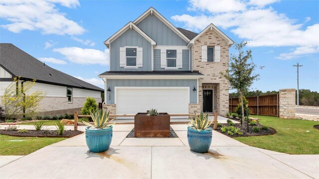 100 Heatherwood Ter, Marble Falls, TX 78654 - view of front facade with board and batten siding, a garage, driveway, roof with shingles, and brick siding