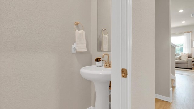 100 Heatherwood Ter, Marble Falls, TX 78654 - bathroom with wood finished floors, a textured wall, recessed lighting, and baseboards
