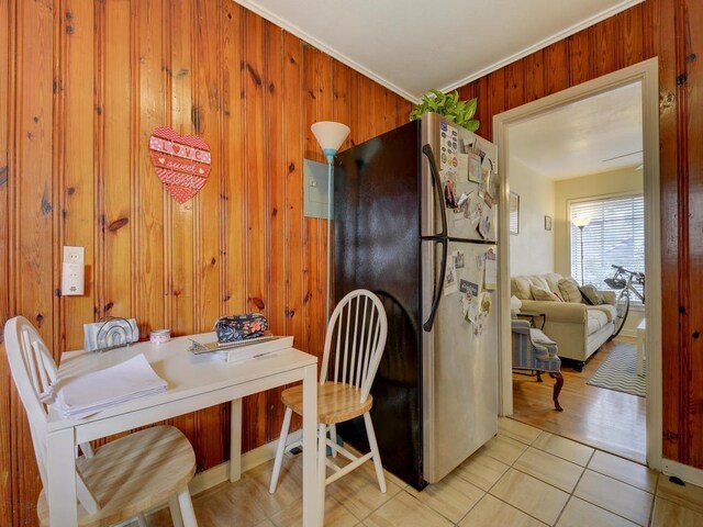 301 E 34th St Unit 107, Austin, TX 78705 - dining room featuring wood walls, ornamental molding, and light tile patterned flooring