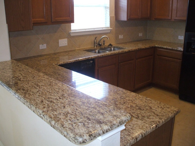10506 Wylie Dr Unit 276, Austin, TX 78748 - kitchen with a sink, a peninsula, decorative backsplash, and light stone countertops