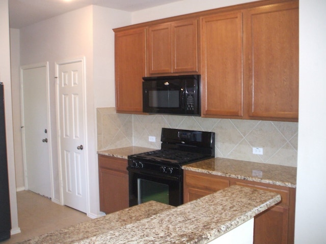10506 Wylie Dr Unit 276, Austin, TX 78748 - kitchen with black appliances, brown cabinets, decorative backsplash, and light stone counters