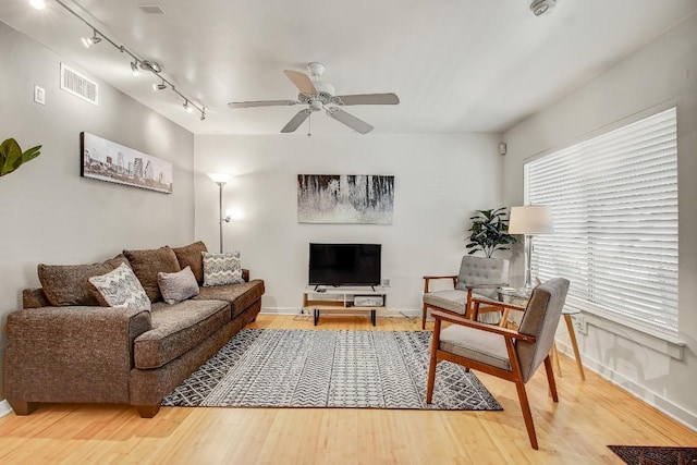 2200 Dickson Dr Unit 132, Austin, TX 78704 - living area with rail lighting, ceiling fan, wood finished floors, and baseboards