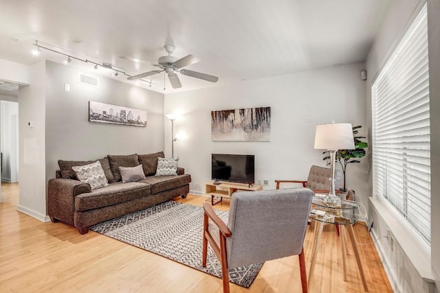 2200 Dickson Dr Unit 132, Austin, TX 78704 - living room with light wood-type flooring, ceiling fan, rail lighting, and baseboards