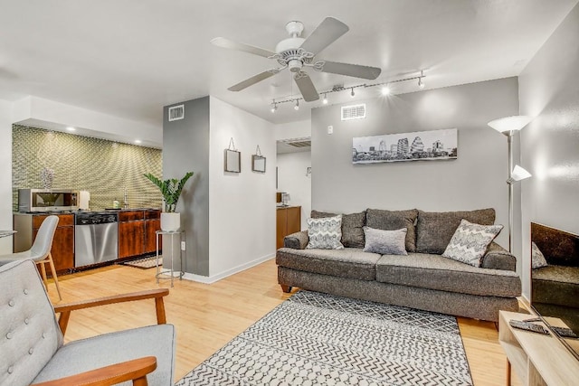 2200 Dickson Dr Unit 132, Austin, TX 78704 - living room featuring rail lighting, ceiling fan, light wood-style floors, and baseboards