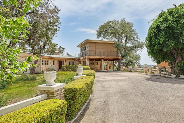 8016 Lupe Ln, Jonestown, TX 78645 - view of front of home featuring a carport, driveway, and a balcony