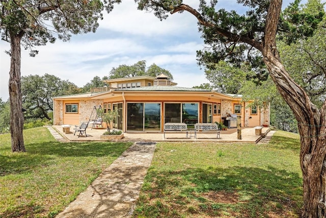 8016 Lupe Ln, Jonestown, TX 78645 - back of property with a patio and a yard