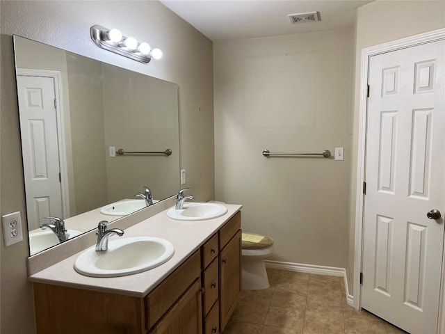 100 Acorn Trl, Cedar Creek, TX 78612 - bathroom featuring double vanity, toilet, baseboards, and tile patterned floors